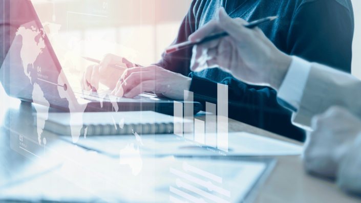 Emprendedor revisando métricas de crecimiento de su startup fintech, con gráficos de datos y tecnología financiera en pantalla.